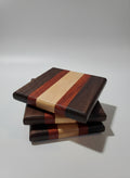 Stack of wooden coasters with different wood walnut/paduk/maple